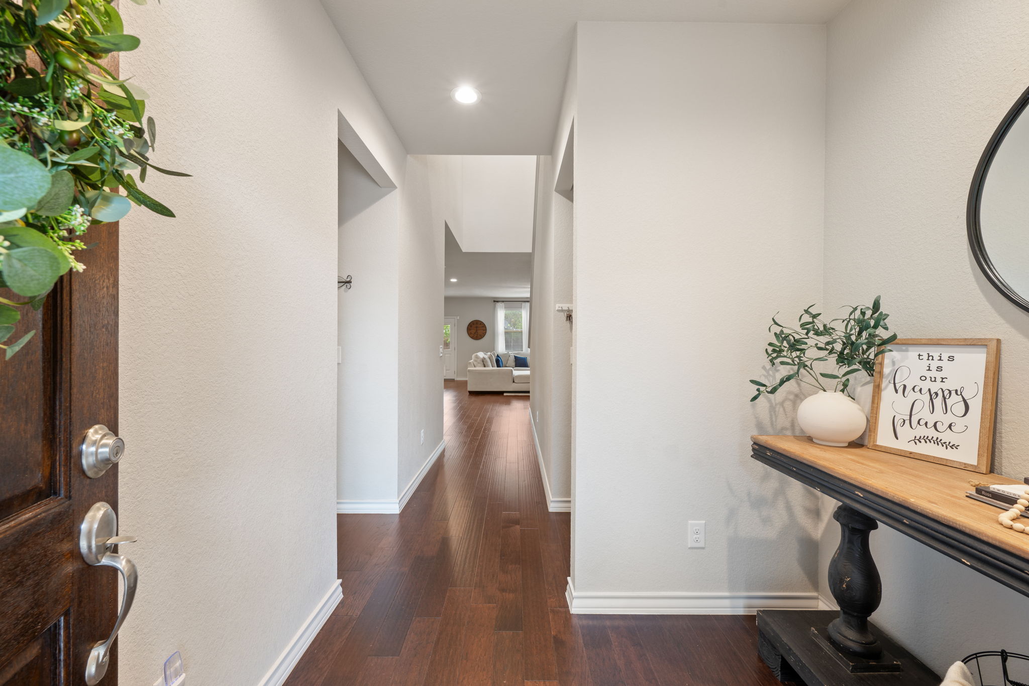 409 Limestone Road Liberty Hill, TX 78642 - Photo 5 of 35 a view of a hallway with wooden floor and a potted plant