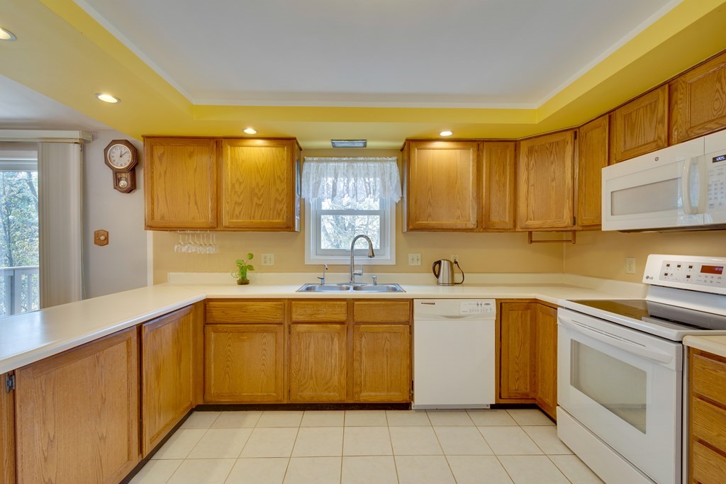 55 Wrentham Road Worcester, MA 01602 - Photo 11 of 30 a kitchen with a sink stove and cabinets