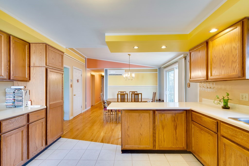 55 Wrentham Road Worcester, MA 01602 - Photo 13 of 30 a large kitchen with stainless steel appliances kitchen island granite countertop a sink and cabinets