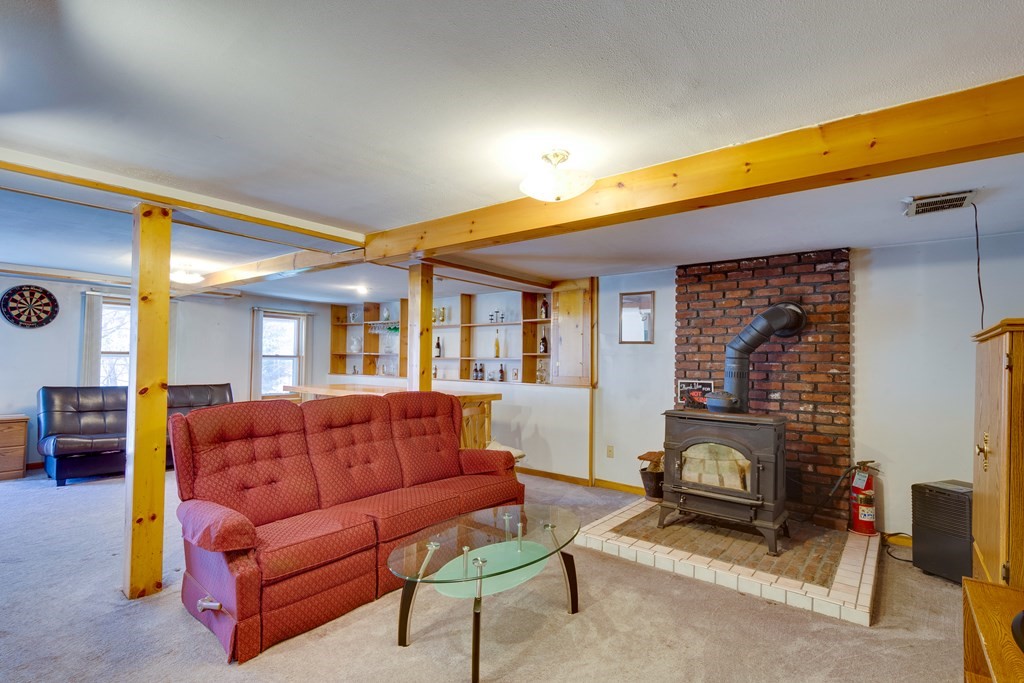 55 Wrentham Road Worcester, MA 01602 - Photo 23 of 30 a living room with furniture a fireplace and a flat screen tv