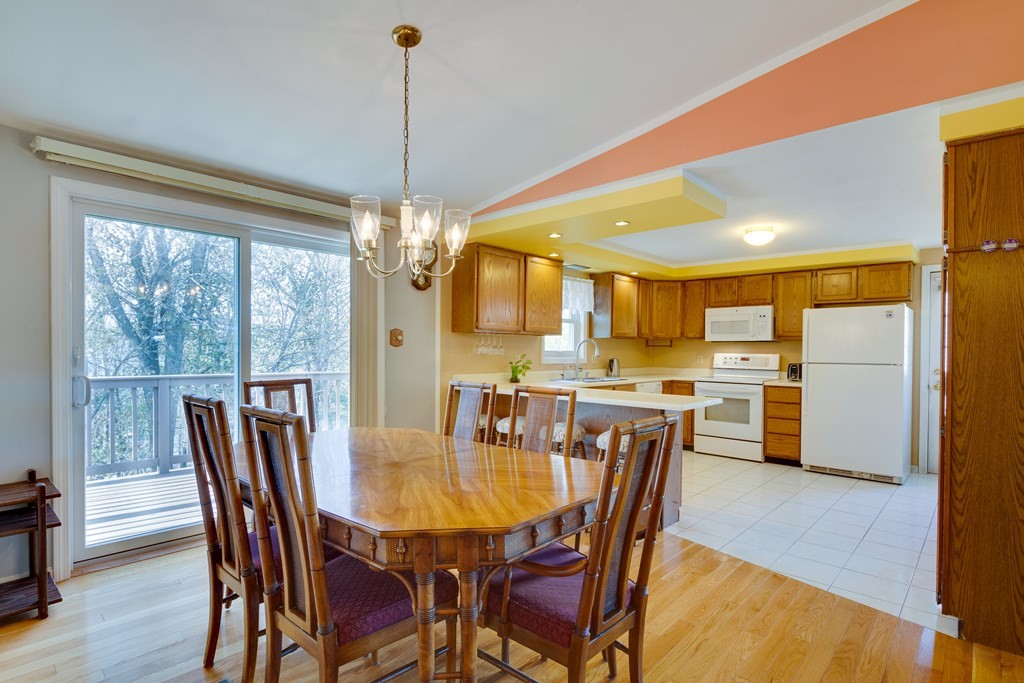 55 Wrentham Road Worcester, MA 01602 - Photo 8 of 30 a dining room with furniture a chandelier and wooden floor