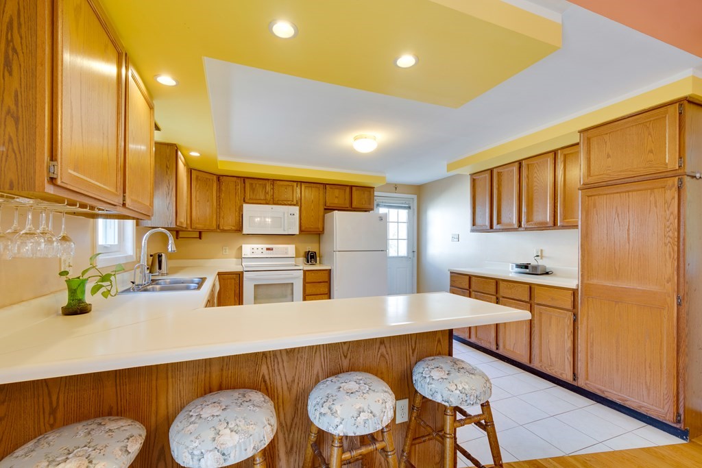 55 Wrentham Road Worcester, MA 01602 - Photo 9 of 30 a kitchen with stainless steel appliances a sink a stove a refrigerator cabinets and dining table