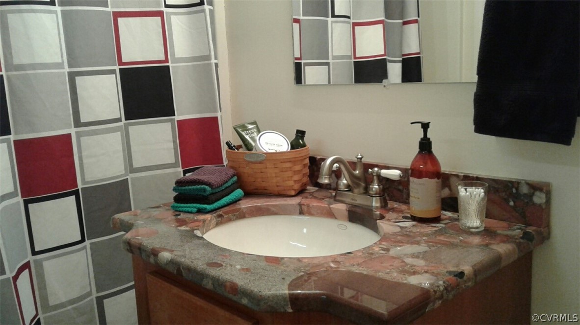 1863 Buffalo Road Dillwyn, VA 23936 - Photo 11 of 27 a bathroom with a granite countertop sink and a mirror