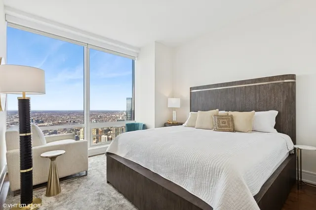 a bedroom with a bed lamp and window