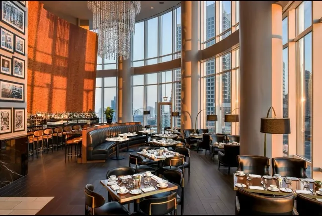 a living room with furniture and floor to ceiling windows