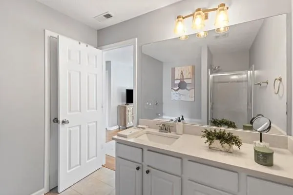 a bathroom with a double vanity sink and a mirror