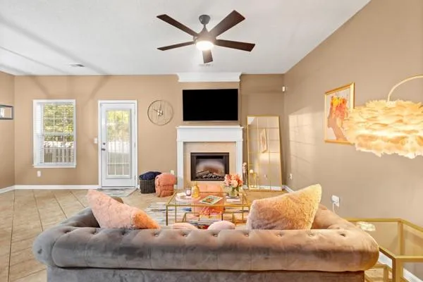a living room with furniture fireplace and a large window