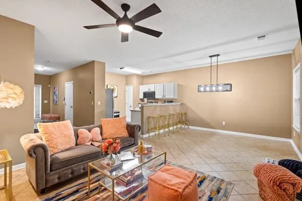 a living room with furniture ceiling fan and a rug