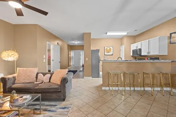 a living room with furniture and kitchen view