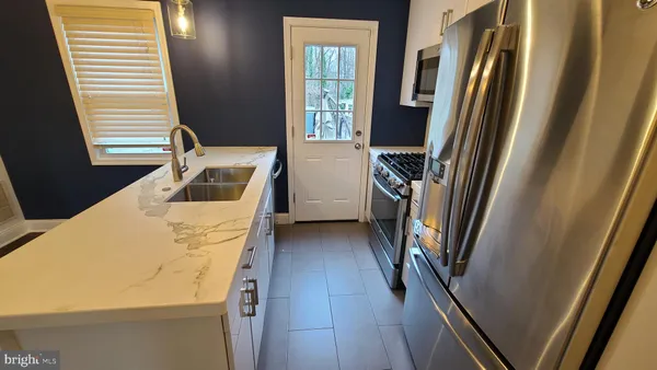 a kitchen with windows and refrigerator