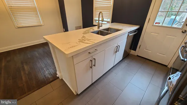 a kitchen with stainless steel appliances granite countertop a refrigerator stove and microwave