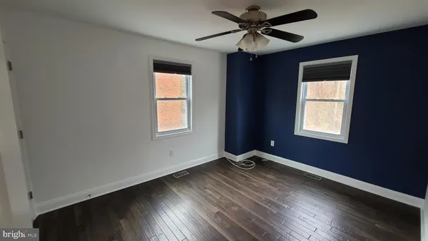a view of a livingroom with a window and wooden floor