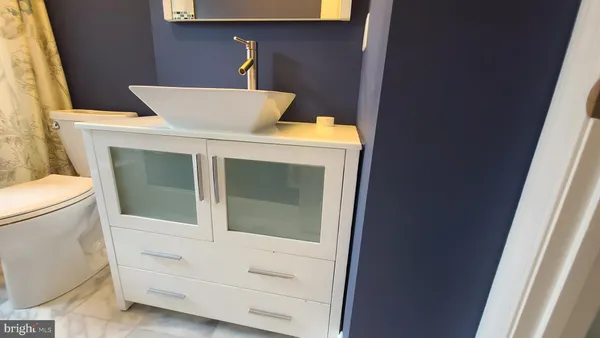 a bathroom with a glass shower door