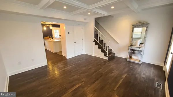 a view of entryway with wooden floor and stairs