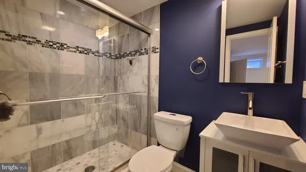 a bathroom with a shower toilet and sink