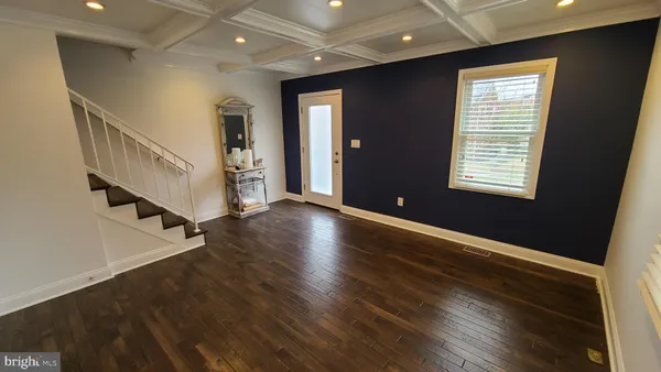 a view of an entryway with wooden floor