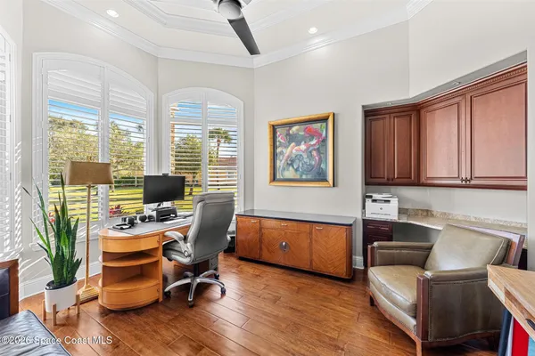 a view of a kitchen with furniture and wooden floor
