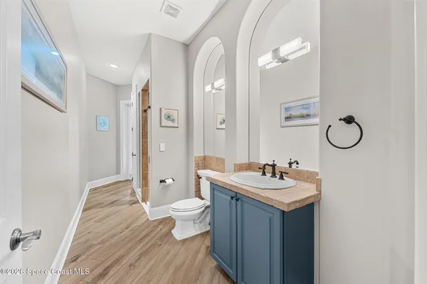 a living room with furniture and a wooden floor