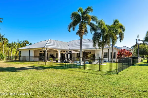 an aerial view of a house with a garden and swimming pool