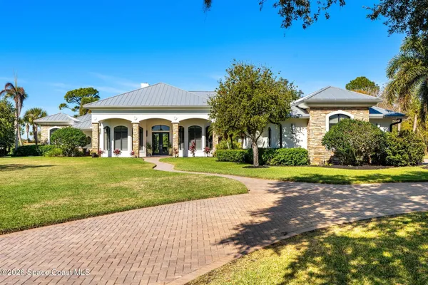 a living room with furniture a fireplace and a large window