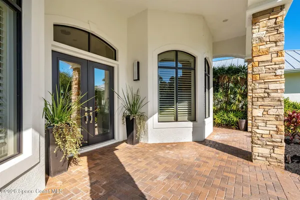 a living room with furniture a fireplace and a large window