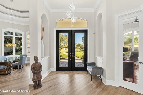 a living room with furniture a fireplace and a large window
