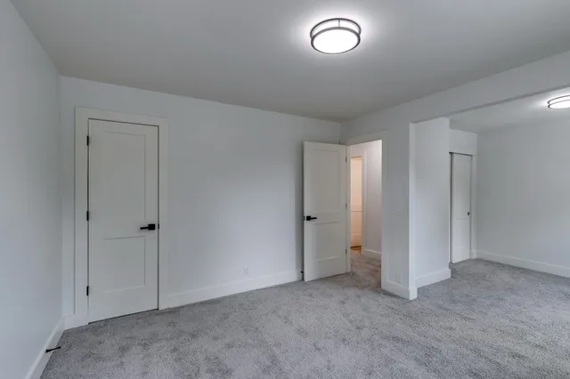 an empty room with windows and closet