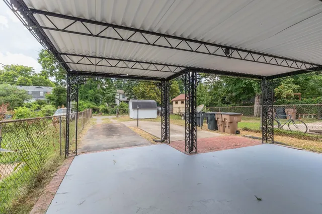 a view of a house with a yard and sitting area