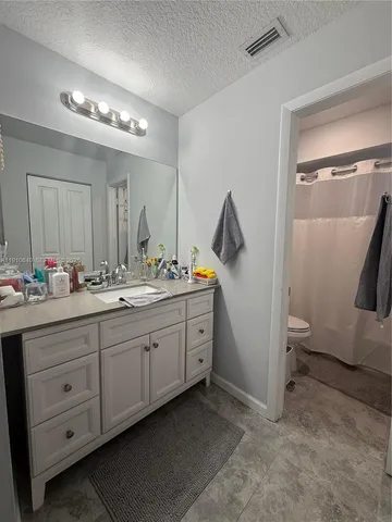 a spacious bathroom with a double vanity sink and a mirror