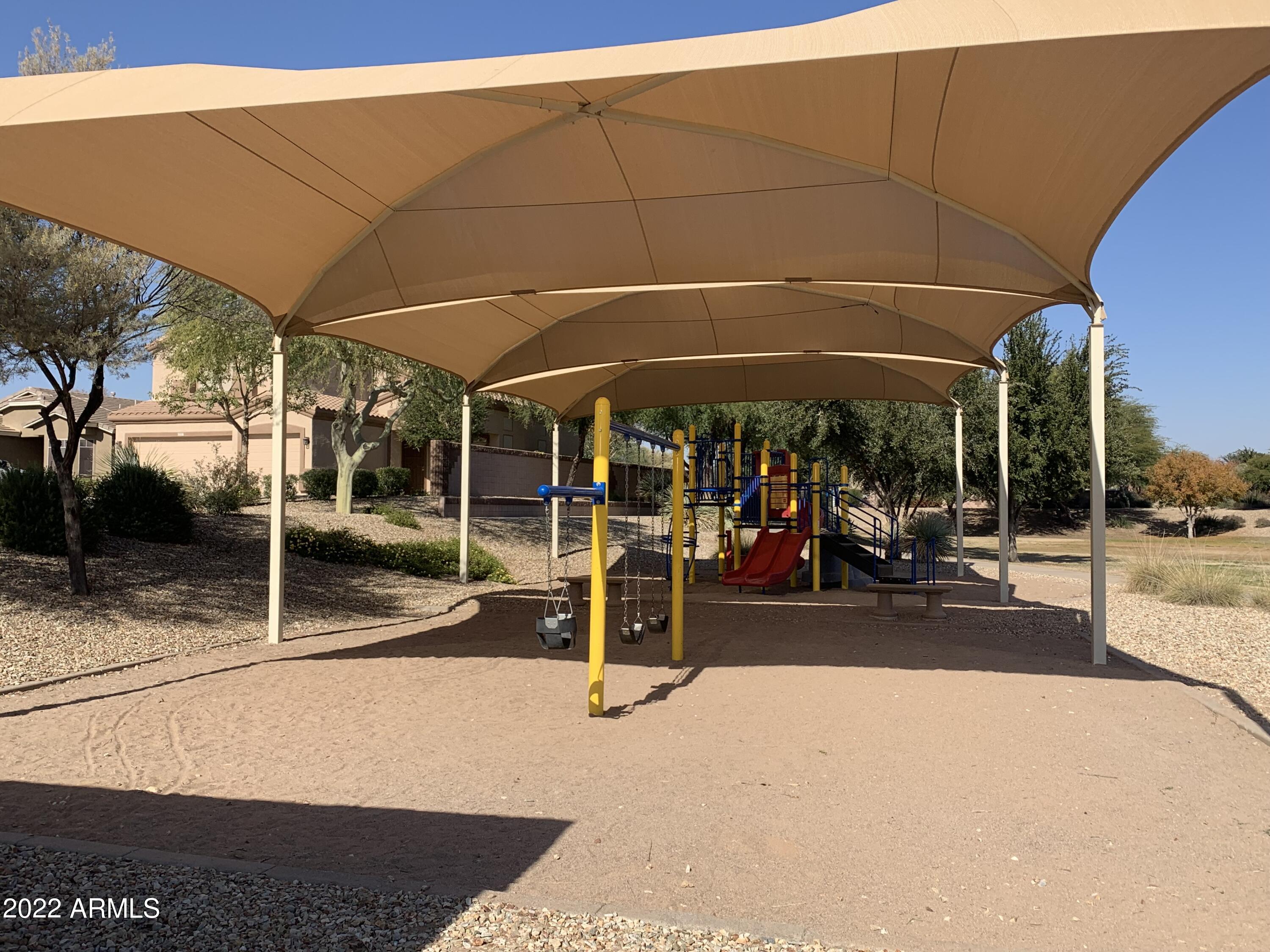 15973 West Calavar Road Surprise, AZ 85379 - Photo 25 of 27 a view of a patio with a table and chairs under an umbrella