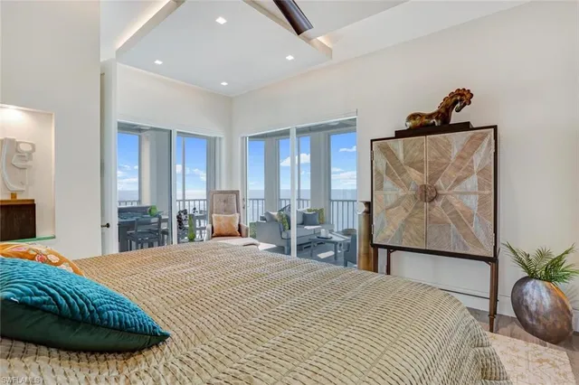 a bedroom with a bed a couch and dresser