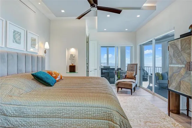 a bedroom with a bed couch and a view of living room