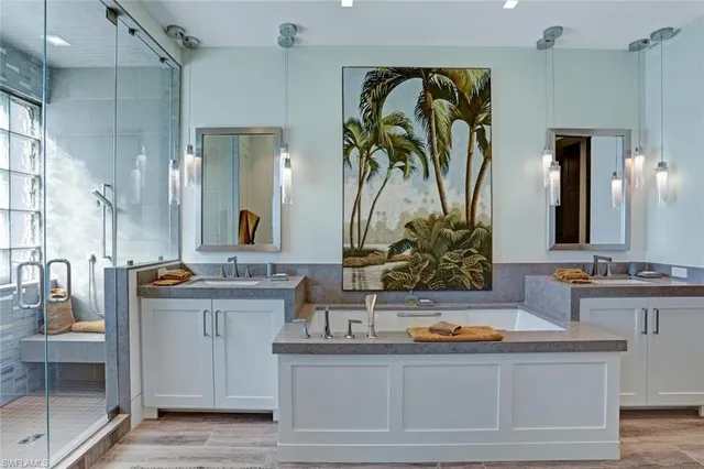a bathroom with a granite countertop sink a mirror and shower