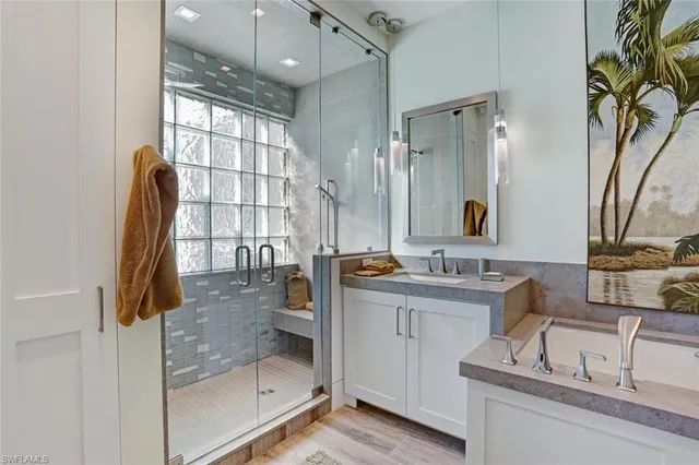 a bedroom with a large bed a rug and painting on the wall