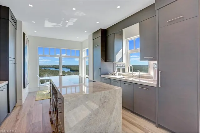 a kitchen with granite countertop a sink and a refrigerator
