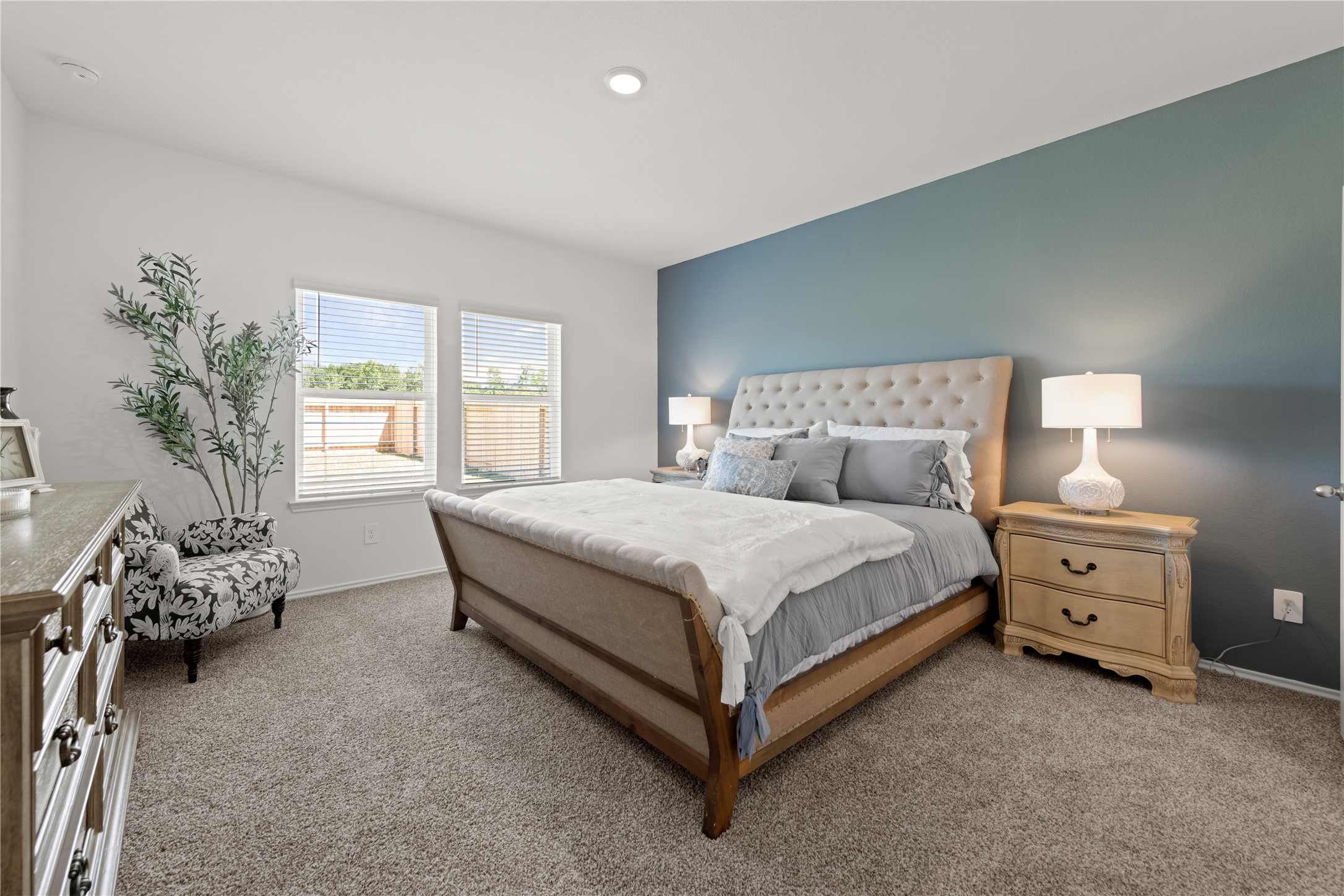 545 Wax Myrtle Way Hockley, TX 77447 - Photo 5 of 9 a bed sitting in a bedroom next to a window with lamp