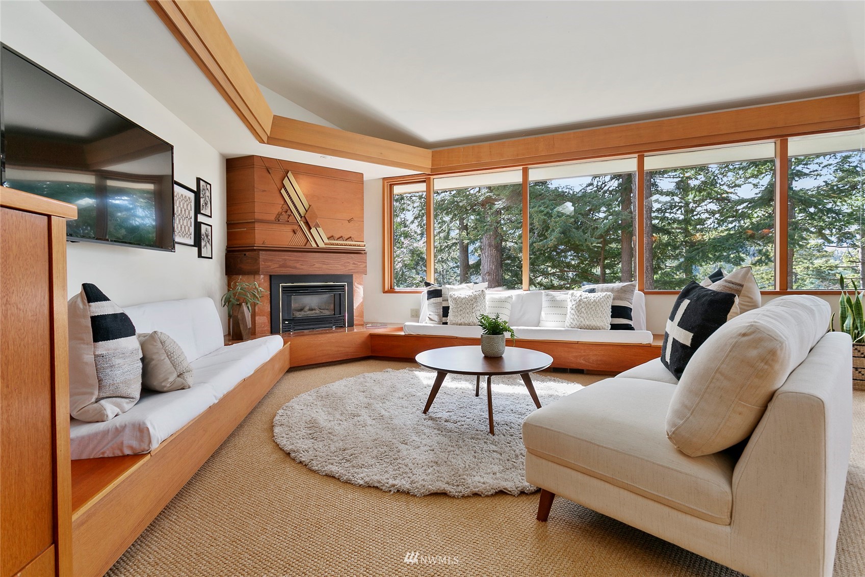 312 Sea Pines Road Bellingham, WA 98229 - Photo 8 of 39 a living room with furniture a fireplace and a floor to ceiling window