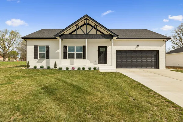 a front view of a house with a garden