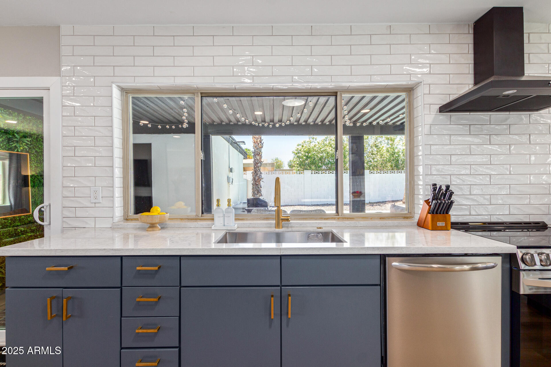 6612 East Presidio Road Scottsdale, AZ 85254 - Photo 15 of 54 a kitchen with granite countertop a sink and a white wooden cabinets