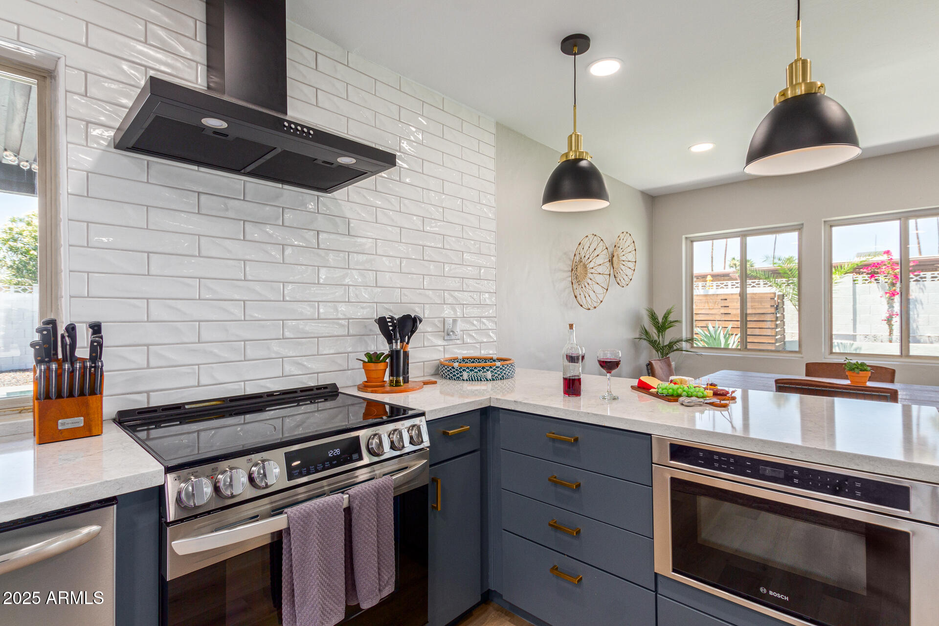6612 East Presidio Road Scottsdale, AZ 85254 - Photo 16 of 54 a kitchen with a stove and a wooden floor