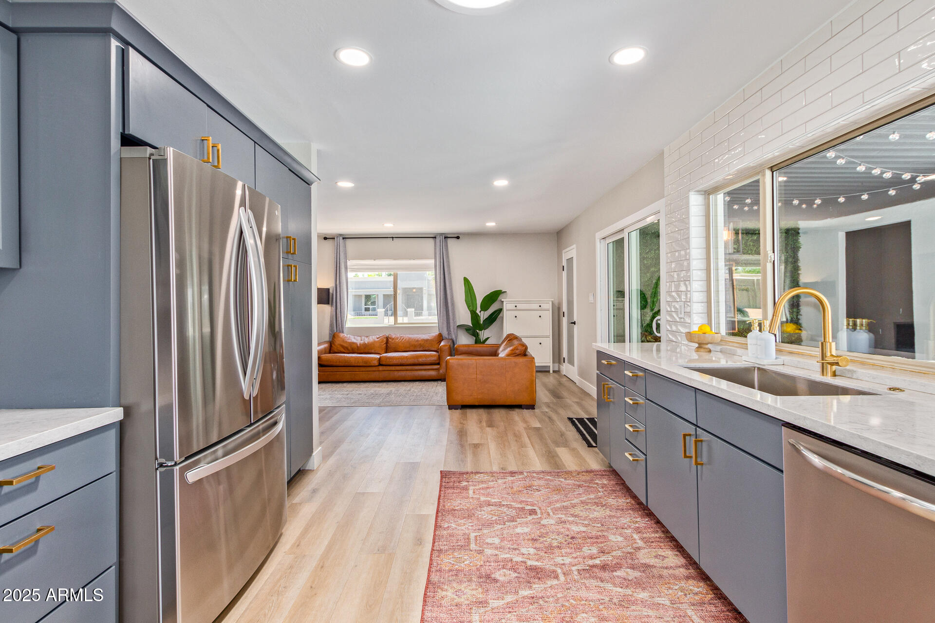 6612 East Presidio Road Scottsdale, AZ 85254 - Photo 17 of 54 a kitchen with stainless steel appliances granite countertop a refrigerator and a sink