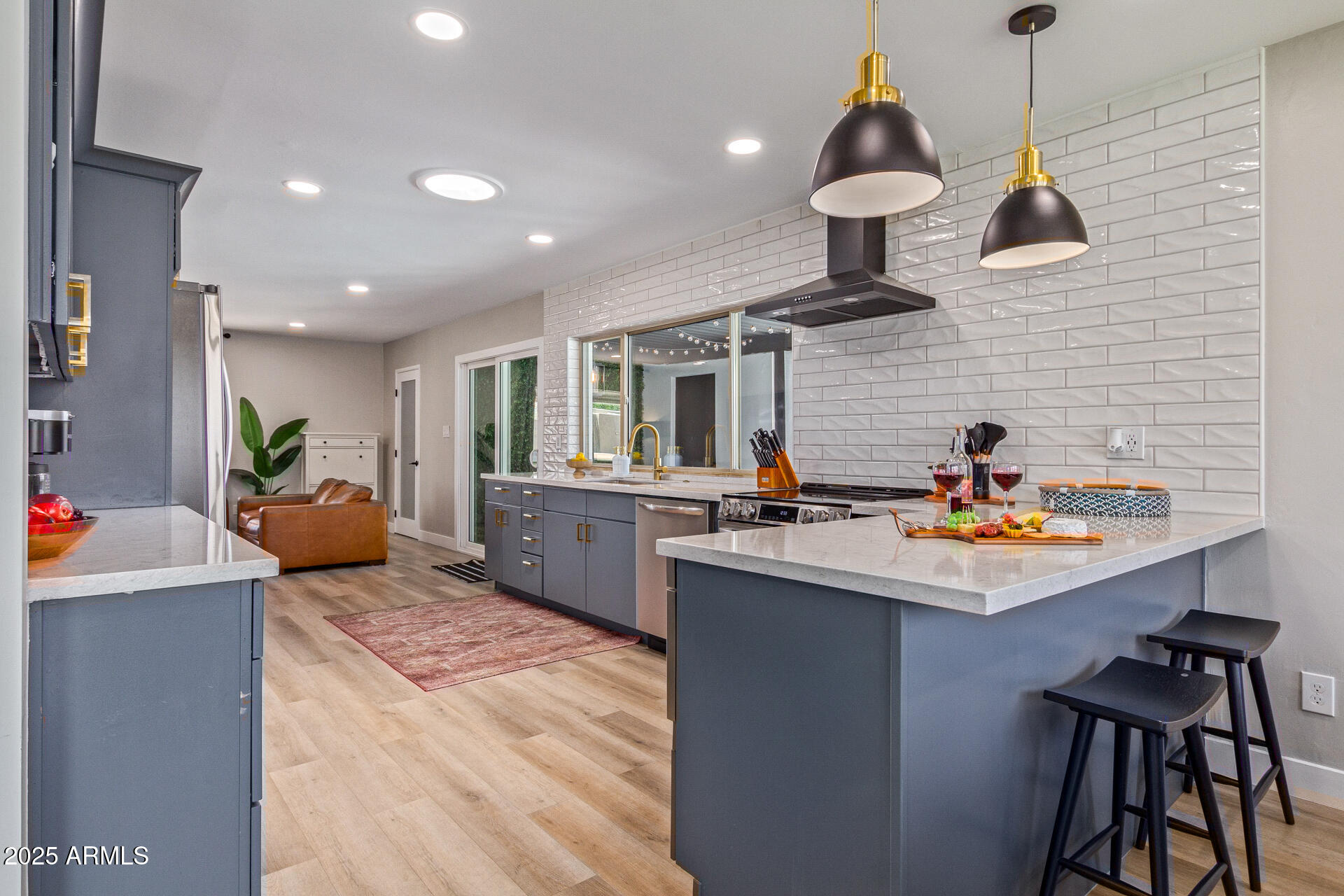 6612 East Presidio Road Scottsdale, AZ 85254 - Photo 18 of 54 a kitchen with stainless steel appliances granite countertop a sink a stove and a wooden floors