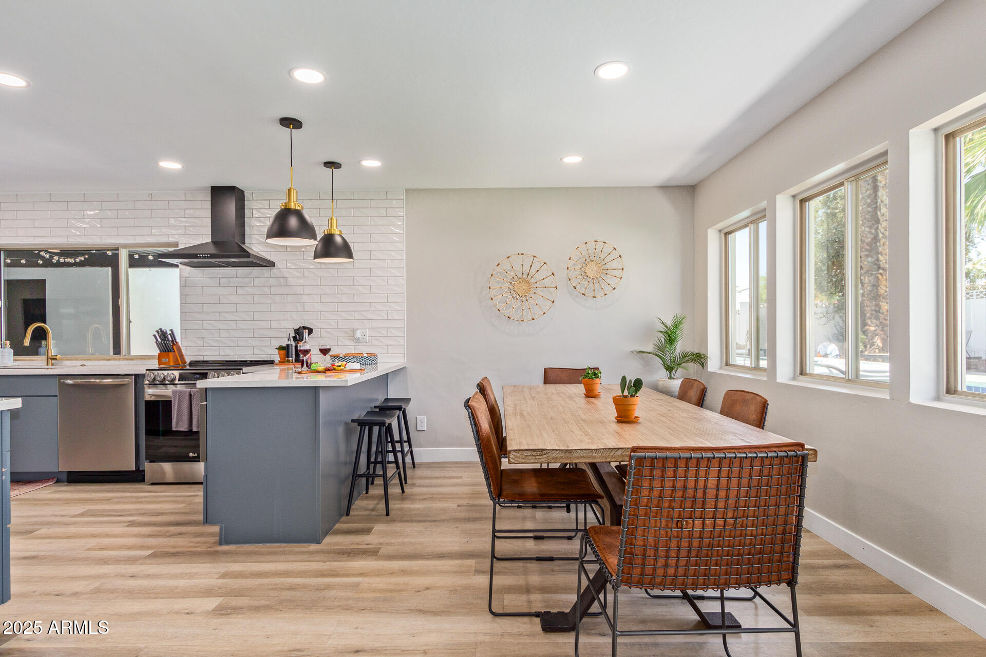 6612 East Presidio Road Scottsdale, AZ 85254 - Photo 3 of 54 a dining room with a wooden table and chairs