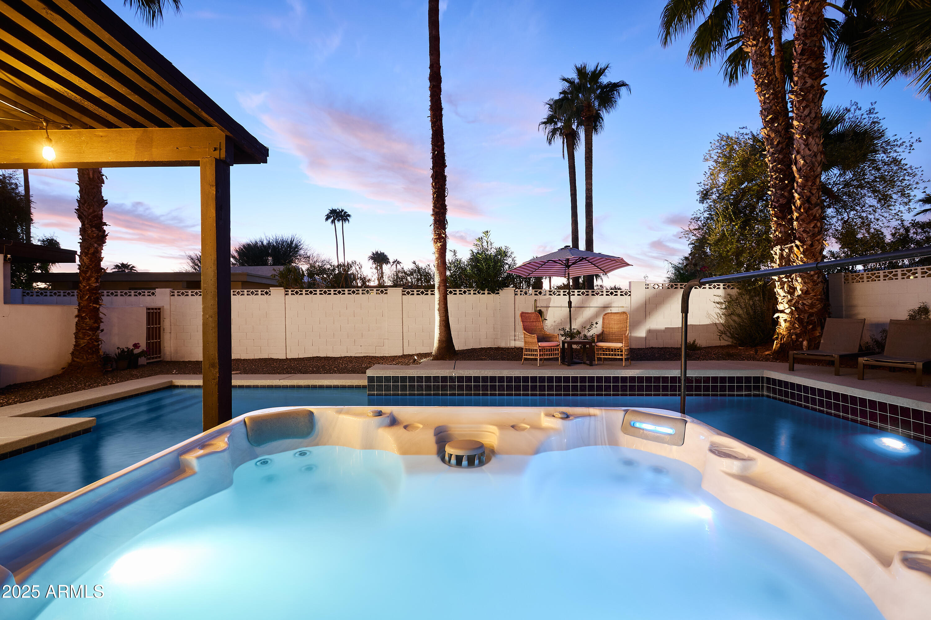 6612 East Presidio Road Scottsdale, AZ 85254 - Photo 43 of 54 a view of swimming pool with a table and chairs