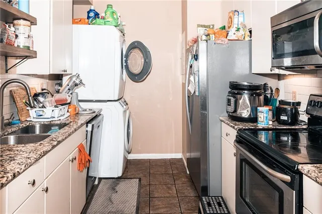 a kitchen with stainless steel appliances granite countertop a refrigerator and a stove top oven