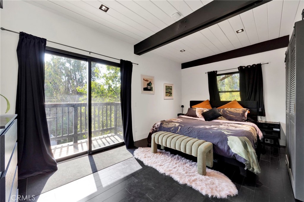 4009 Weslin Avenue Sherman Oaks, CA 91423 - Photo 13 of 44 a bedroom with a large bed and a balcony view