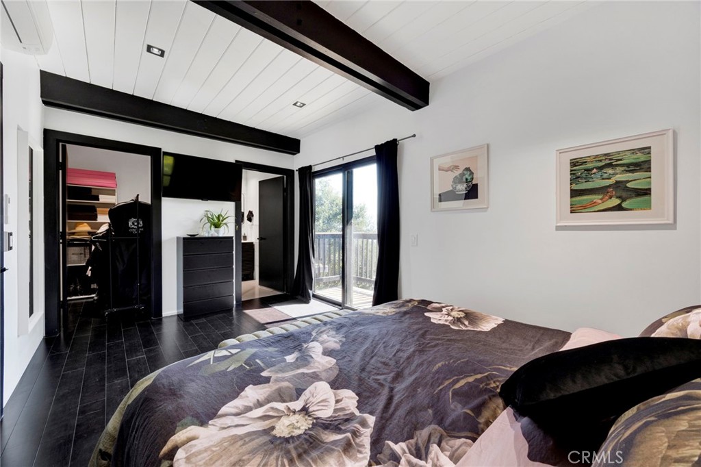 4009 Weslin Avenue Sherman Oaks, CA 91423 - Photo 14 of 44 a bedroom with a bed and a large mirror