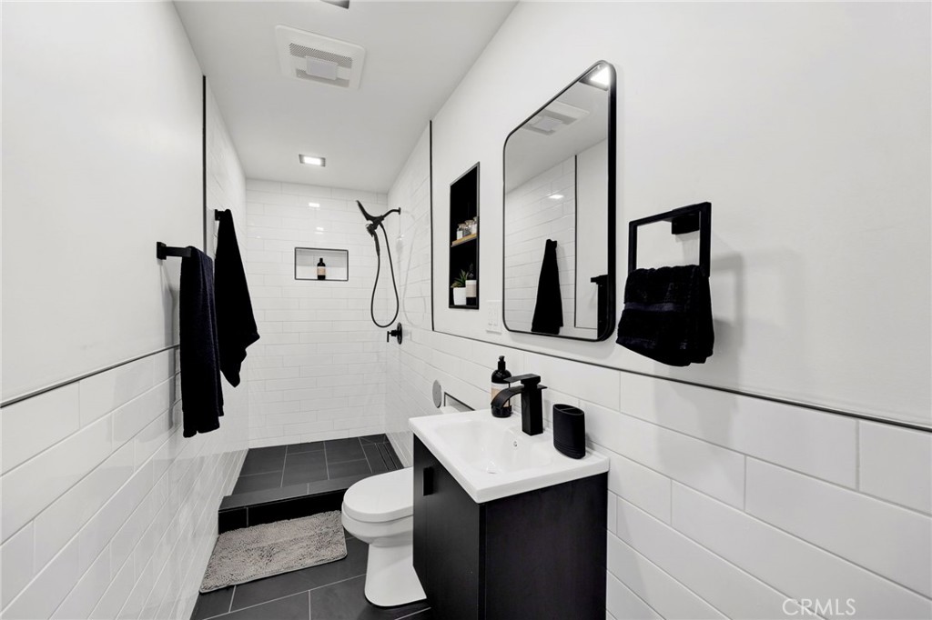 4009 Weslin Avenue Sherman Oaks, CA 91423 - Photo 30 of 44 a bathroom with a sink a toilet and mirror