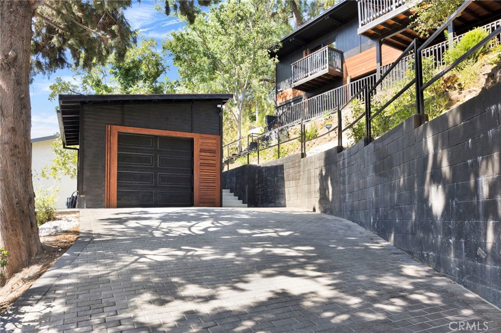 4009 Weslin Avenue Sherman Oaks, CA 91423 - Photo 36 of 44 a front view of a house with a yard and garage
