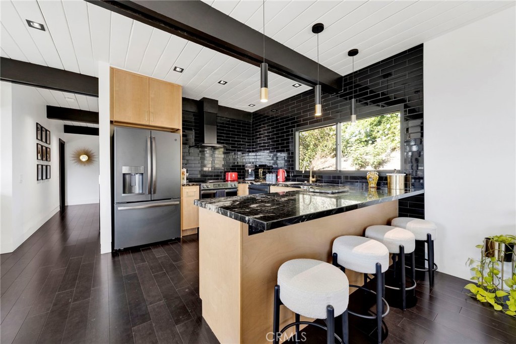 4009 Weslin Avenue Sherman Oaks, CA 91423 - Photo 7 of 44 a kitchen with stainless steel appliances granite countertop a sink and a refrigerator